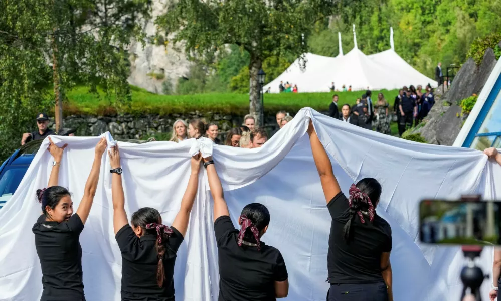 Staff members hold up white sheets to hide the bride and groom on the day of the wedding of Norway's Princess Martha Louise and Durek Verrett, in Geiranger, Norway, August 31, 2024. NTB/Cornelius Poppe via REUTERS  ATTENTION EDITORS - THIS IMAGE WAS PROVIDED BY A THIRD PARTY. NORWAY OUT. NO COMMERCIAL OR EDITORIAL SALES IN NORWAY.