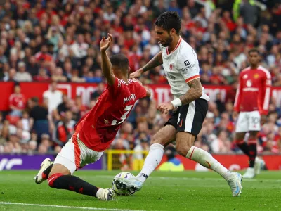 Soccer Football - Premier League - Manchester United v Liverpool - Old Trafford, Manchester, Britain - September 1, 2024 Manchester United's Noussair Mazraoui in action with Liverpool's Dominik Szoboszlai REUTERS/Molly Darlington EDITORIAL USE ONLY. NO USE WITH UNAUTHORIZED AUDIO, VIDEO, DATA, FIXTURE LISTS, CLUB/LEAGUE LOGOS OR 'LIVE' SERVICES. ONLINE IN-MATCH USE LIMITED TO 120 IMAGES, NO VIDEO EMULATION. NO USE IN BETTING, GAMES OR SINGLE CLUB/LEAGUE/PLAYER PUBLICATIONS. PLEASE CONTACT YOUR ACCOUNT REPRESENTATIVE FOR FURTHER DETAILS..