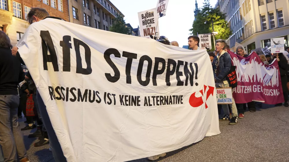 Participants in a demonstration against the right hold a banner with the slogan "Stop AfD! Racism is not an alternative" in Hamburg, Sunday, Sept. 1, 2024. (Bodo Marks/dpa via AP)