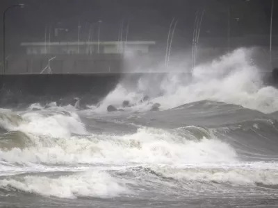 High waves hit the shore in Miyazaki, southern Japan, Sunday, Sept. 18, 2022, as a powerful typhoon approaching southern Japan on Sunday lashed the region with strong winds and heavy rain.(Kyodo News via AP)