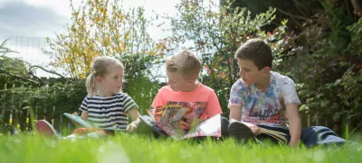 children reading in the garden