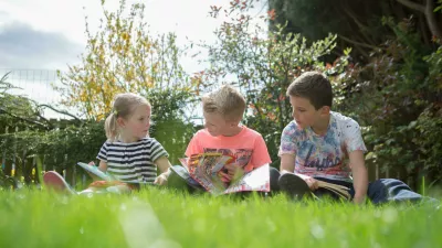 children reading in the garden