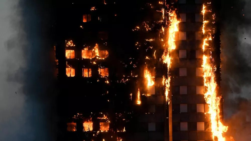 FILE PHOTO: The Grenfell Tower residential building is seen on fire in London, Britain, June 14, 2017. REUTERS/Toby Melville/File Photo