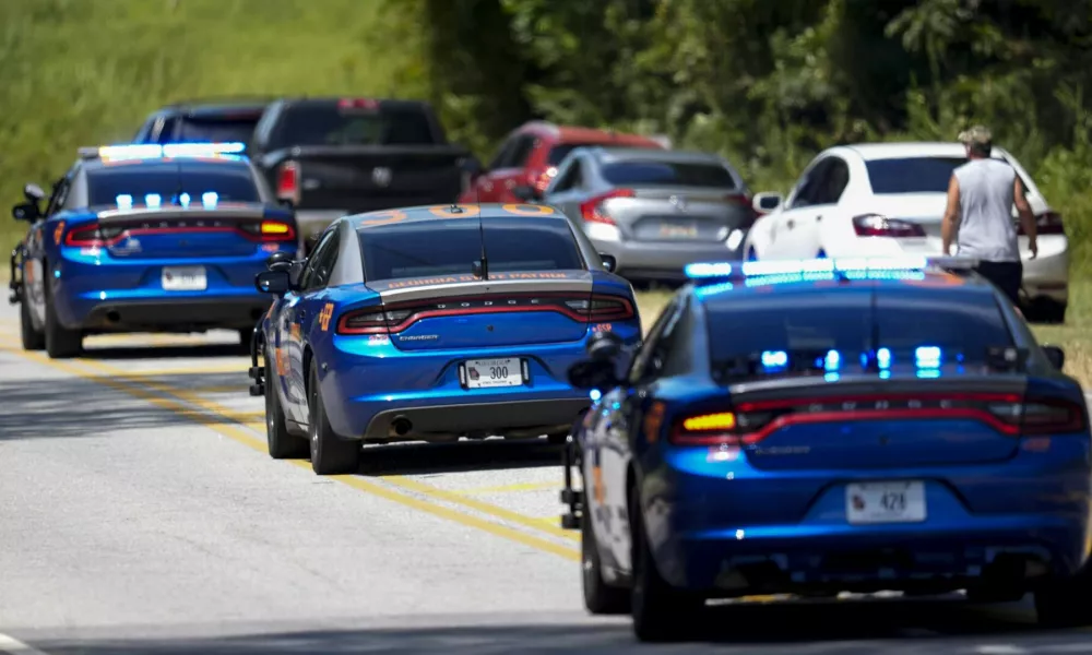 Georgia State patrol vehicles move toward Apalachee High School after a shooting at the school, Wednesday, Sept. 4, 2024, in Winder, Ga. (AP Photo/Mike Stewart)