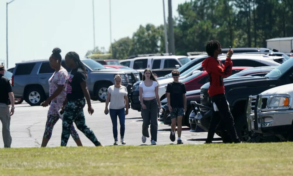 People walk near the scene of a shooting at Apalachee High School in Winder, Georgia, U.S. September 4, 2024. REUTERS/Elijah Nouvelage