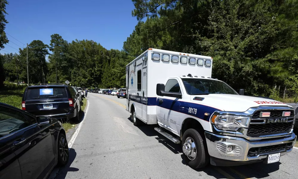 An ambulance departs Apalachee High School, after a shooting at the school Wednesday, Sept. 4, 2024, in Winder, Ga. (AP Photo/Mike Stewart)