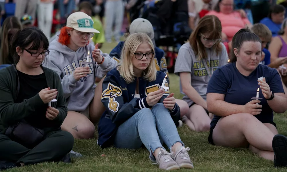 People hold candles while attending a vigil at Jug Tavern Park following a shooting at Apalachee High School in Winder, Georgia, U.S. September 4, 2024. REUTERS/Elijah Nouvelage