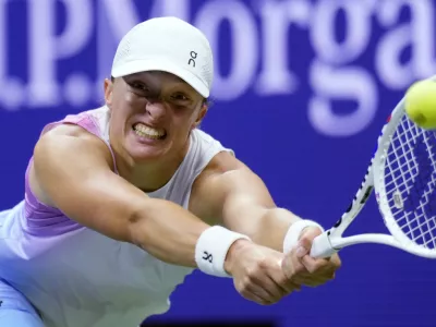 Iga Świątek, of Poland, returns to Jessica Pegula, of the United States, during the quarterfinals of the U.S. Open tennis championships, Wednesday, Sept. 4, 2024, in New York. (AP Photo/Eduardo Munoz Alvarez)