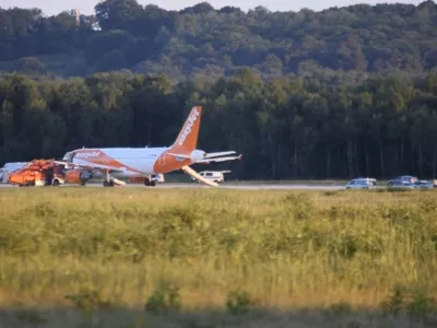 ﻿In this June 10, 2017 photo taken from video, a EasyJet plane stands at Cologne-Bonn airport, in Cologne Germany. German police are questioning three British citizens after their conversation during a flight to London prompted an EasyJet pilot to make an unscheduled stop in Cologne late Saturday. A spokesman for Cologne police says other passengers on the flight from the Slovenian capital Ljubljana overheard a conversation with "terrorist content" between the men, aged 31, 38 and 48. Airport authorities said in a statement that the 151 passengers on board disembarked the plane using emergency slides. (Thomas Kraus/dpa via AP)