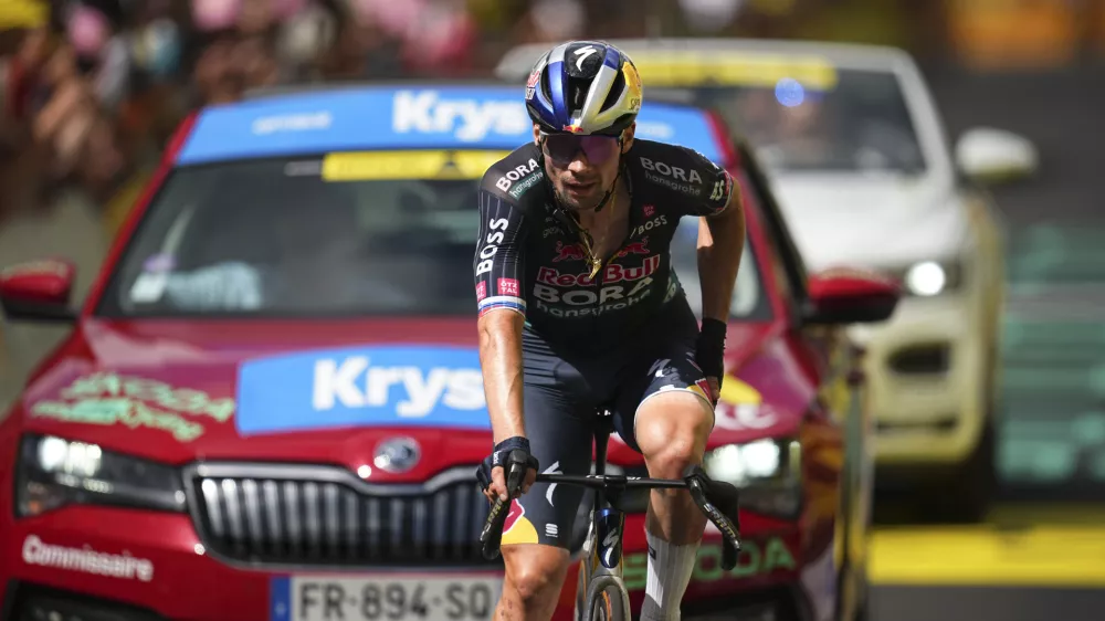 Slovenia's Primoz Roglic, who crashed in the final descent, crosses the finish line of the eleventh stage of the Tour de France cycling race over 211 kilometers (131.1 miles) with start in Evaux-les-Bains and finish in Le Lioran, France, Wednesday, July 10, 2024. (AP Photo/Daniel Cole)