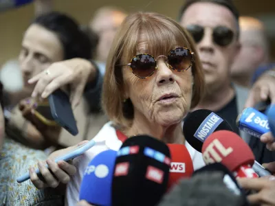 Gisele Pelicot speaks to media as she leaves the Avignon court house, southern France, Thursday, Sept. 5, 2024. A woman allegedly drugged by her ex-husband so that she could be raped by other men while she laid unconscious, is expected to testify before a panel of French judges. (AP Photo/Lewis Joly)