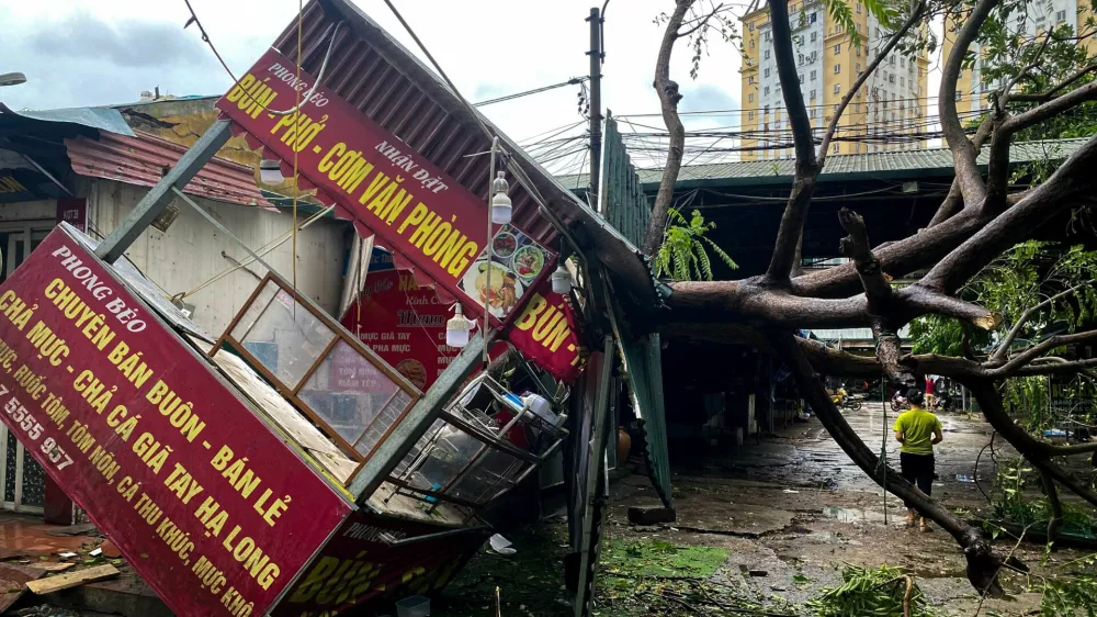 A man walks past a devastated area following the impact of Typhoon Yagi, in Hanoi, Vietnam, September 8, 2024. REUTERS/Thinh Nguyen