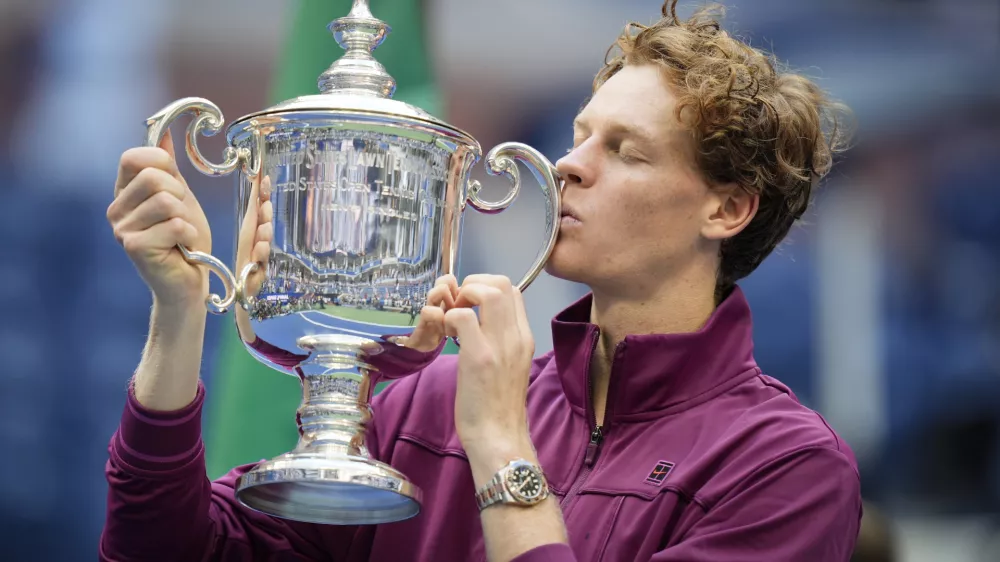 Jannik Sinner, of Italy, kisses the championship trophy after defeating Taylor Fritz, of the United States, in the men's singles final of the U.S. Open tennis championships, Sunday, Sept. 8, 2024, in New York. (AP Photo/Seth Wenig)