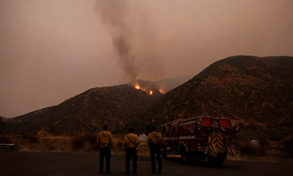 Firefighters monitor the progression of the Line Fire in the San Bernardino National Forest's mountains over Highland, California, U.S. September 8, 2024. REUTERS/Etienne Laurent