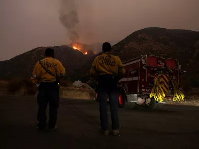 Firefighters monitor the progression of the Line Fire in the San Bernardino National Forest's mountains over Highland, California, U.S. September 8, 2024. REUTERS/Etienne Laurent