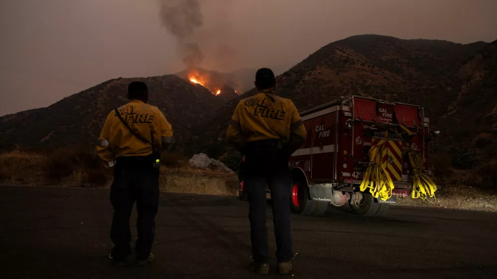 Firefighters monitor the progression of the Line Fire in the San Bernardino National Forest's mountains over Highland, California, U.S. September 8, 2024. REUTERS/Etienne Laurent