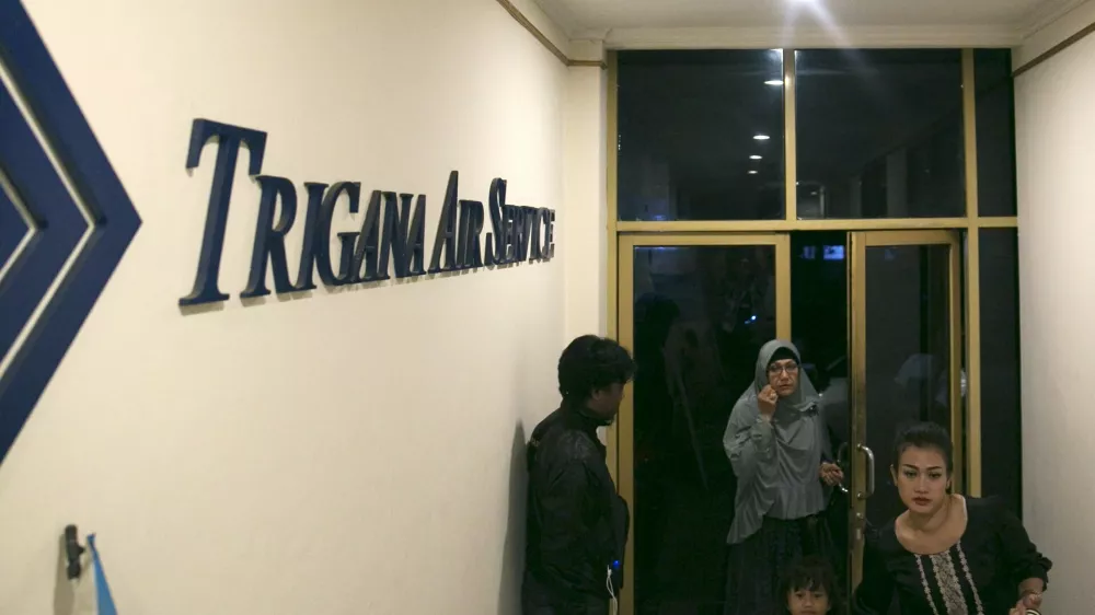 ﻿People walk into the entrance of Trigana Air's office in Jakarta, Indonesia August 16, 2015. Villagers in Indonesia's remote and mountainous eastern Papua region reported that an aircraft had crashed, a Trigana Air official said on Sunday, several hours after an aircraft carrying 54 people went missing, media reports said. REUTERS/Darren Whiteside