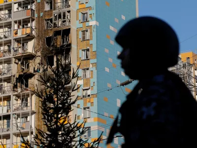 A law enforcement officer stands guard near a damaged multi-storey residential building following an alleged Ukrainian drone attack in the course of Russia-Ukraine conflict, in Ramenskoye in the Moscow region, Russia September 10, 2024. REUTERS/Maxim Shemetov   TPX IMAGES OF THE DAY