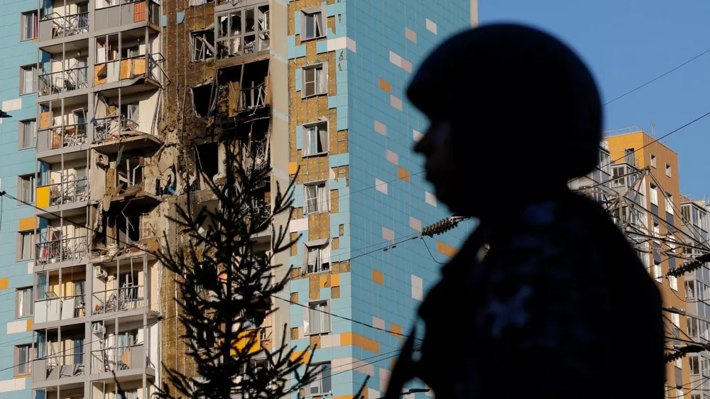 A law enforcement officer stands guard near a damaged multi-storey residential building following an alleged Ukrainian drone attack in the course of Russia-Ukraine conflict, in Ramenskoye in the Moscow region, Russia September 10, 2024. REUTERS/Maxim Shemetov   TPX IMAGES OF THE DAY