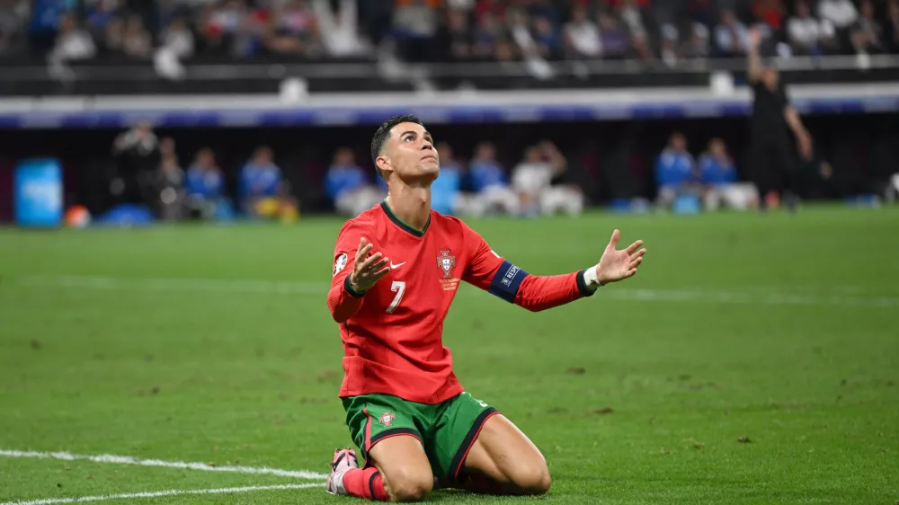 01 July 2024, Hesse, Frankfurt/Main: Portugal's Cristiano Ronaldo sits disappointed on the pitch after missing a chance to score during the UEFA Euro 2024 round of 16 football match between Portugal and Slowenien at the Frankfurt Arena. Photo: Arne Dedert/dpa