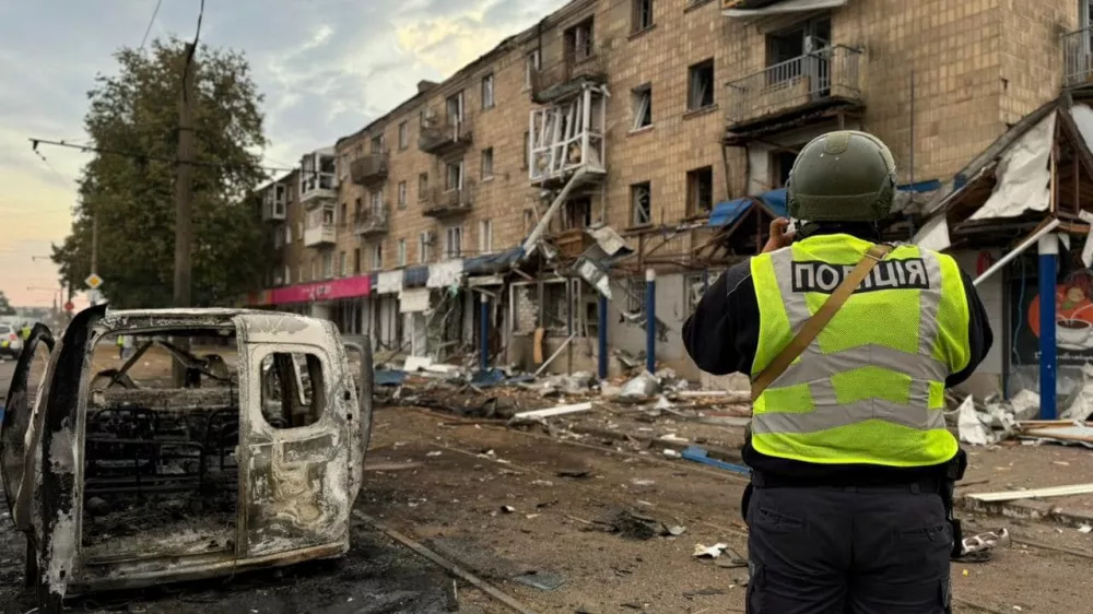 A police officer takes a picture of a residential building damaged during a Russian drone strike, amid Russia's attack on Ukraine, in the town of Konotop, Sumy region, Ukraine September 12, 2024. Press service of the National Police of Ukraine in Sumy region/Handout via REUTERS ATTENTION EDITORS - THIS IMAGE HAS BEEN SUPPLIED BY A THIRD PARTY. DO NOT OBSCURE LOGO.