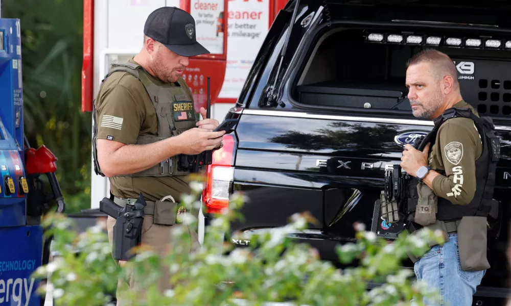 Law enforcement officers stand after reports of shots fired outside Republican presidential nominee and former U.S. President Donald Trump's Trump International Golf Course in West Palm Beach, Florida, U.S. September 15, 2024. REUTERS/Marco Bello