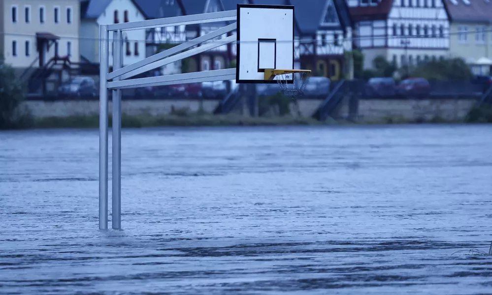 A basketball hoop stands in the flood waters of the Elbe in Bad Schandau, Germany Monday, Sept. 16, 2024. (Jan Woitas/dpa via AP)