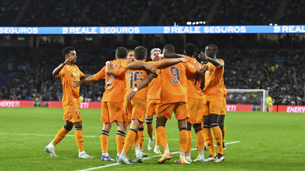 Real Madrid's Kylian Mbappe, centre right, celebrates with team mates after scoring his side's second goal from a penalty kick during a Spanish La Liga soccer match between Real Sociedad and Real Madrid at the Reale Arena in San Sebastian, Spain, Saturday, Sept. 14, 2024. (AP Photo/Miguel Oses)