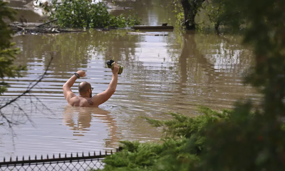 A man wades through flood water in Opava, Czech Republic, Sunday Sept. 15, 2024. (Jaroslav Ozana/CTK via AP)