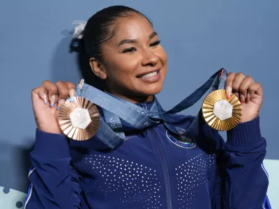 FILE - Jordan Chiles, of the United States, holds up her medals after the women's artistic gymnastics individual apparatus finals Bercy Arena at the 2024 Summer Olympics, Aug. 5, 2024, in Paris, France. (AP Photo/Charlie Riedel, File)