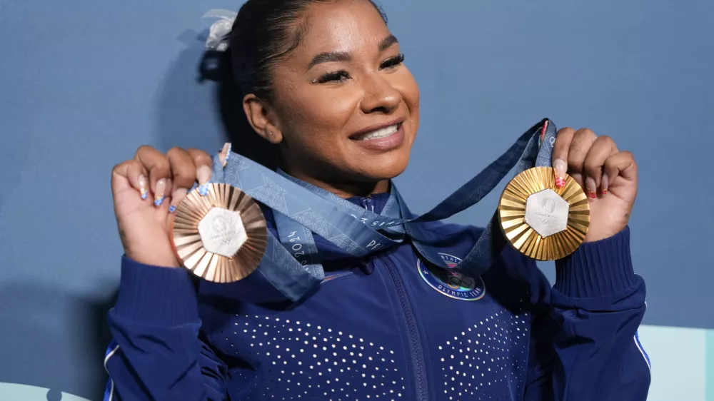 FILE - Jordan Chiles, of the United States, holds up her medals after the women's artistic gymnastics individual apparatus finals Bercy Arena at the 2024 Summer Olympics, Aug. 5, 2024, in Paris, France. (AP Photo/Charlie Riedel, File)