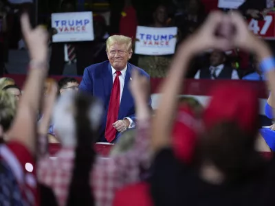 Republican presidential candidate former President Donald Trump, left, on stage with Arkansas Gov. Sarah Huckabee Sanders, right, during a town hall event at the Dort Financial Center, Tuesday, Sept. 17, 2024, in Flint, Mich. (AP Photo/Evan Vucci)