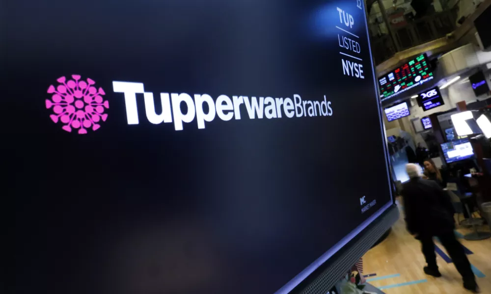 FILE - The logo for Tupperware Brands appears on a monitor on the floor of the New York Stock Exchange on Oct. 30, 2019. (AP Photo/Richard Drew, File)