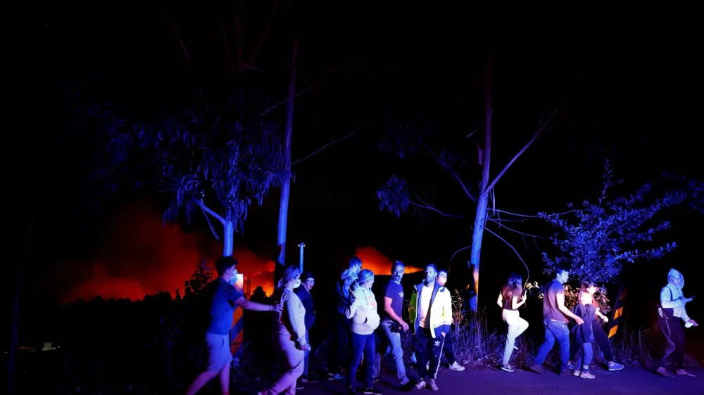 People watching a wildfire make room for emergency vehicles in the vicinity of Soutelo, Portugal, September 17, 2024. REUTERS/Susana Vera