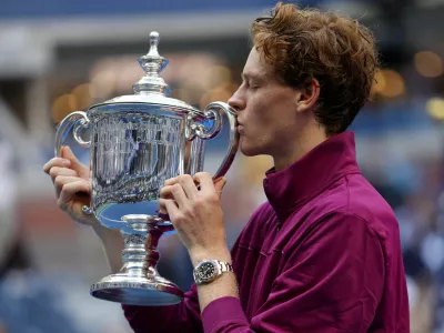 FILE PHOTO: Tennis - U.S. Open - Flushing Meadows, New York, United States - September 8, 2024 Italy's Jannik Sinner celebrates with the trophy after winning his final match against Taylor Fritz of the U.S. REUTERS/Mike Segar/File Photo