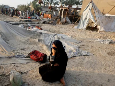 FILE PHOTO: A Palestinian woman reacts at the site following Israeli strikes on a tent camp sheltering displaced people, amid the Israel-Hamas conflict, at the Al-Mawasi area in Khan Younis, in the southern Gaza Strip, September 10, 2024. REUTERS/Mohammed Salem/File Photo