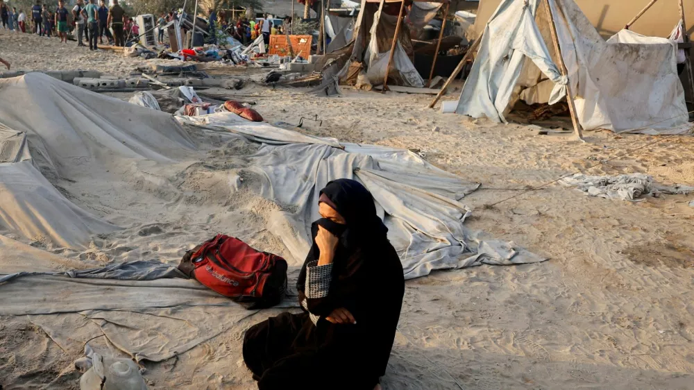 FILE PHOTO: A Palestinian woman reacts at the site following Israeli strikes on a tent camp sheltering displaced people, amid the Israel-Hamas conflict, at the Al-Mawasi area in Khan Younis, in the southern Gaza Strip, September 10, 2024. REUTERS/Mohammed Salem/File Photo