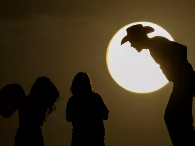 People watch the full moon on the day of the lunar eclipse at the Samalayuca Dunes on the outskirts of Ciudad Juarez, Mexico, September 17, 2024. REUTERS/Jose Luis Gonzalez   TPX IMAGES OF THE DAY