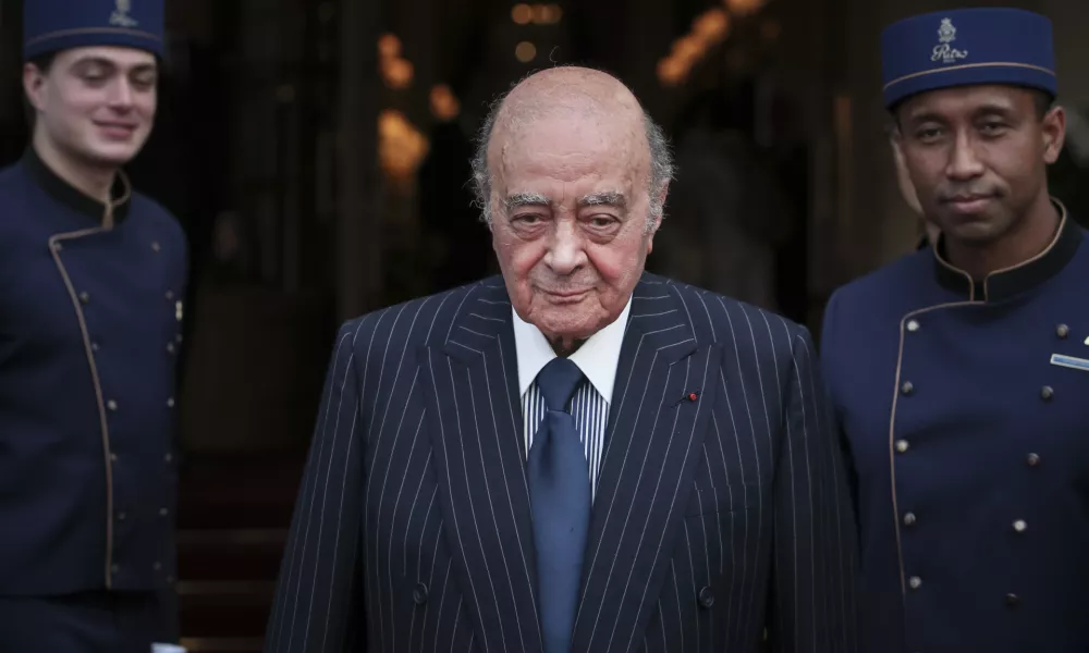 FILE - Egyptian businessman and Ritz hotel owner Mohamed Al Fayed poses with his hotel staff in Paris, June 27, 2016. Al Fayed, the former Harrods owner whose son Dodi was killed in a car crash with Princess Diana, has died at age 94. His death was announced Friday, Sept. 1, 2023, by Fulham Football Club, which Al Fayed once owned. (AP Photo/Kamil Zihnioglu, File)