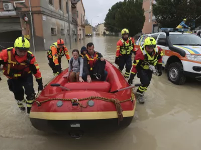 Firefighters use a dingy boat to evacuate civilians after flooding in Faenza, in the region of Emilia Romagna, Italy, Thursday, Sept. 19, 2024. (Fabrizio Zani/LaPresse via AP)