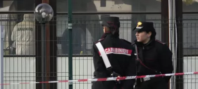 Italian Carabinieri patrol in front of a bar where three people died after a man entered and shot in Rome, Sunday, Dec. 11, 2022. (AP Photo/Gregorio Borgia)