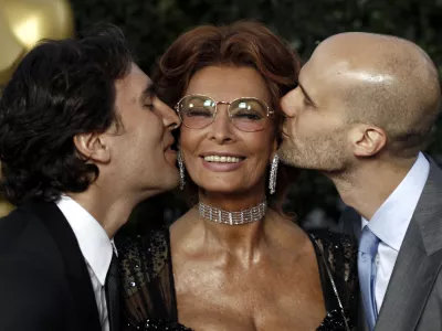 Actress Sophia Loren, center, gets a kiss from her sons, Carlo Ponti Jr., left, and Edoardo Ponti at The Academy of Motion Picture Arts and Sciences Tribute honoring her in Beverly Hills, Calif., Wednesday, May 4, 2011. Loren's life and career will be celebrated by friends and colleagues Wednesday. (AP Photo/Matt Sayles)