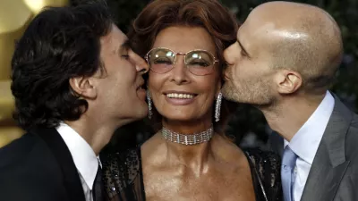 Actress Sophia Loren, center, gets a kiss from her sons, Carlo Ponti Jr., left, and Edoardo Ponti at The Academy of Motion Picture Arts and Sciences Tribute honoring her in Beverly Hills, Calif., Wednesday, May 4, 2011. Loren's life and career will be celebrated by friends and colleagues Wednesday. (AP Photo/Matt Sayles)