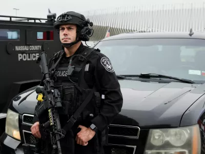 A member of the Nassau County Police Department stand guard outside the Nassau Veterans Memorial Coliseum on the day Republican presidential nominee and former U.S. President Donald Trump will hold a rally, in Uniondale, New York, U.S., September 18, 2024. REUTERS/Brendan McDermid