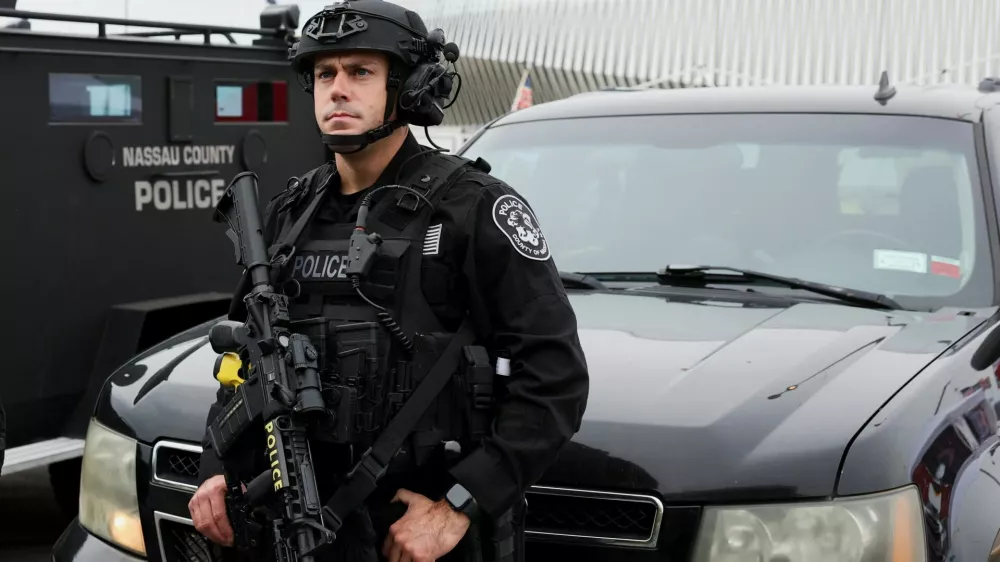 A member of the Nassau County Police Department stand guard outside the Nassau Veterans Memorial Coliseum on the day Republican presidential nominee and former U.S. President Donald Trump will hold a rally, in Uniondale, New York, U.S., September 18, 2024. REUTERS/Brendan McDermid