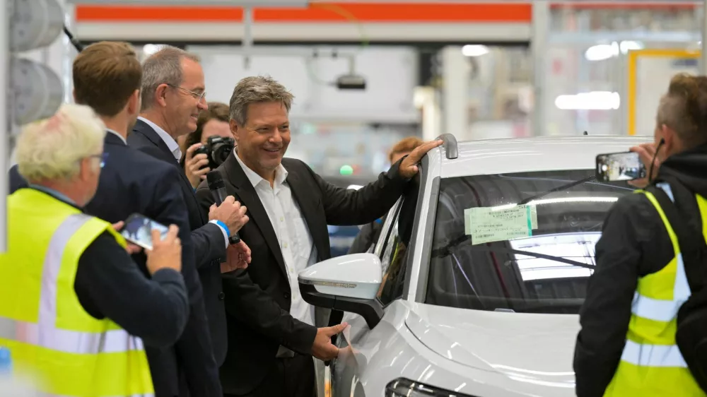 German Economy Minister Robert Habeck poses beside a Volkswagen car during his visit at a Volkswagen plant in Emden, Germany September 20, 2024. REUTERS/Fabian Bimmer