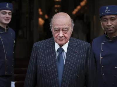 FILE - Egyptian businessman and Ritz hotel owner Mohamed Al Fayed poses with his hotel staff in Paris, June 27, 2016. Al Fayed, the former Harrods owner whose son Dodi was killed in a car crash with Princess Diana, has died at age 94. His death was announced Friday, Sept. 1, 2023, by Fulham Football Club, which Al Fayed once owned. (AP Photo/Kamil Zihnioglu, File)