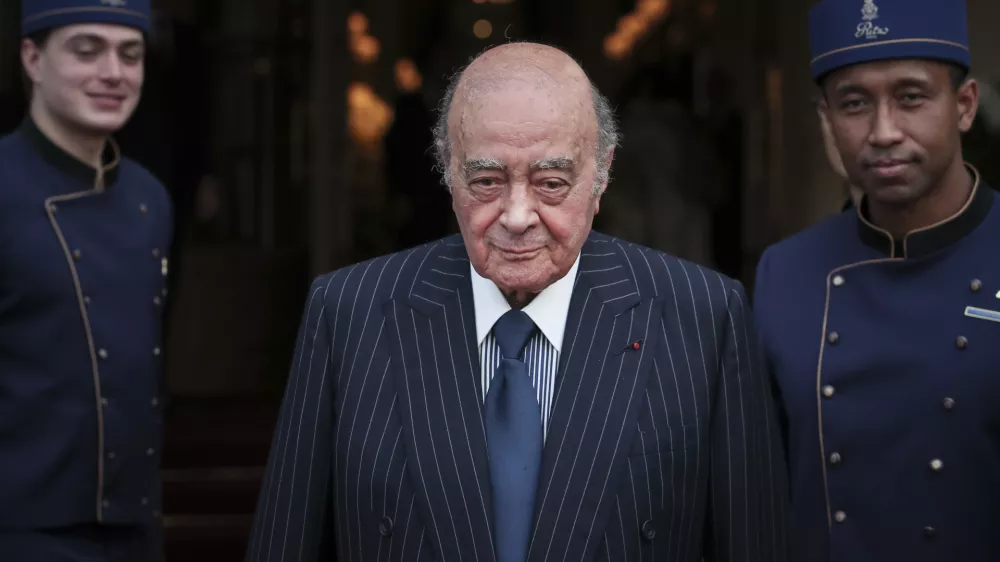 FILE - Egyptian businessman and Ritz hotel owner Mohamed Al Fayed poses with his hotel staff in Paris, June 27, 2016. Al Fayed, the former Harrods owner whose son Dodi was killed in a car crash with Princess Diana, has died at age 94. His death was announced Friday, Sept. 1, 2023, by Fulham Football Club, which Al Fayed once owned. (AP Photo/Kamil Zihnioglu, File)