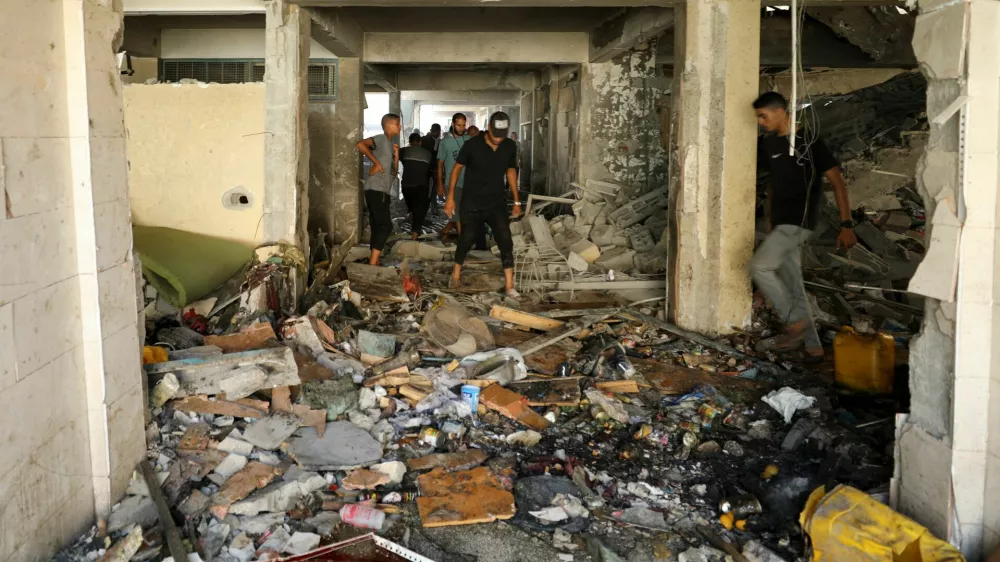 Palestinians inspect a school, which was sheltering displaced people, after it was hit by an Israeli strike, amid the Israel-Hamas conflict, in Gaza City, September 21, 2024. REUTERS/Dawoud Abu Alkas