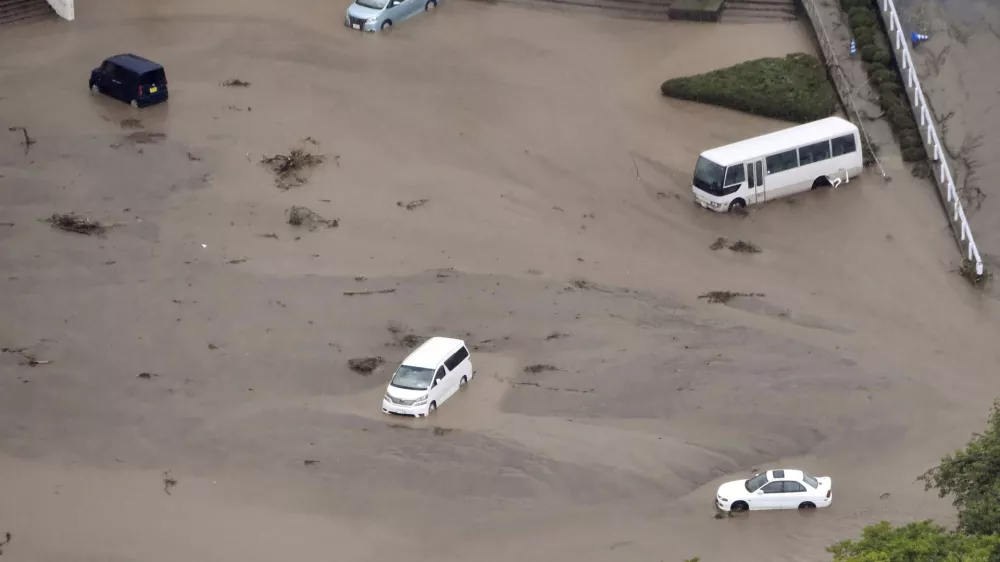 In this aerial photo, the car park of a municipal office is seen under water, after heavy rain in Wajima, Ishikawa prefecture, Saturday, Sept. 21, 2024. (Kyodo News via AP)